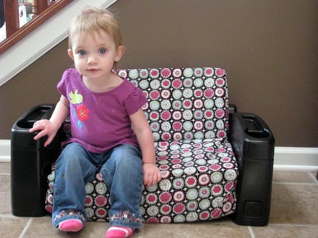 little girl sitting on child sofa