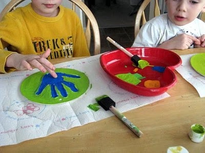 children painting plaster prints