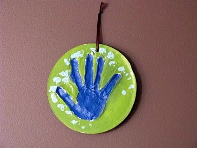 child plaster hand print hung on wall