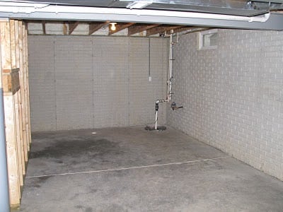 unfinished basement with one framed wall