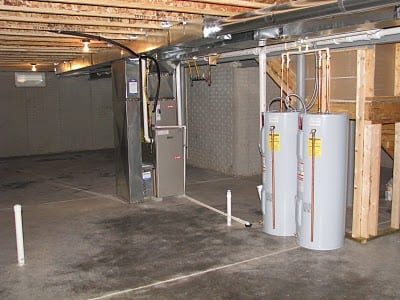 unfinished room with two water heaters