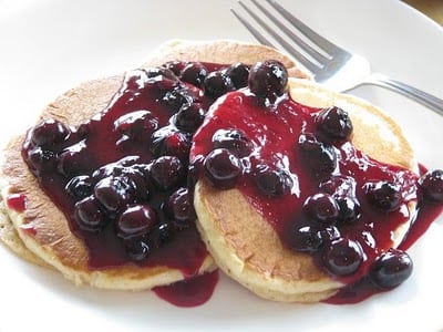 pancakes with blueberry sauce on plate