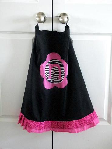 black cape with pink ruffle