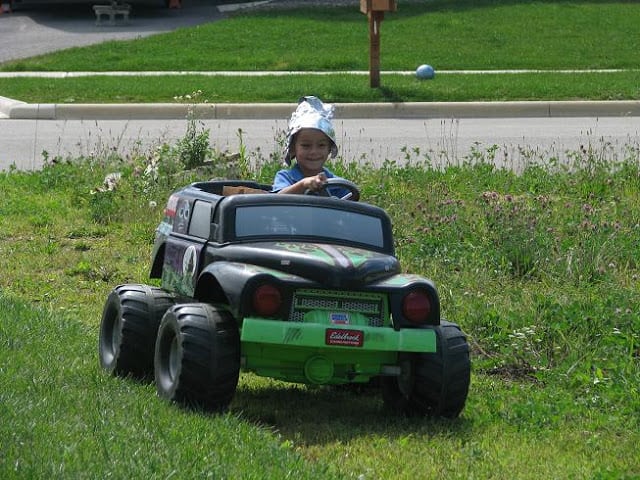child riding in power wheels monster truck