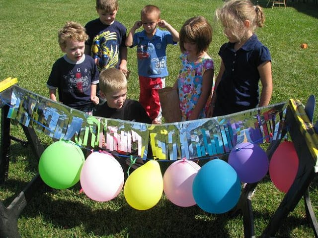 kids popping balloons