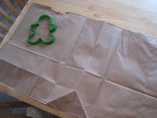 brown bag laid flat with gingerbread cookie cutter