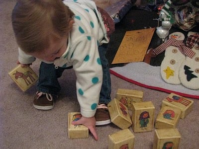 toddler playing with nativity blocks