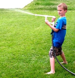 child holding garden hose