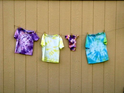 tie dyed shirts hanging on clothes line