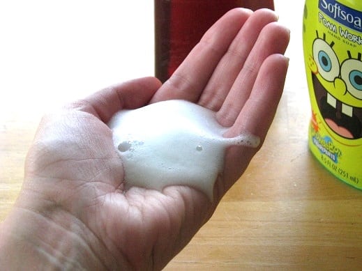 hand stretched out with foaming hand soap on it