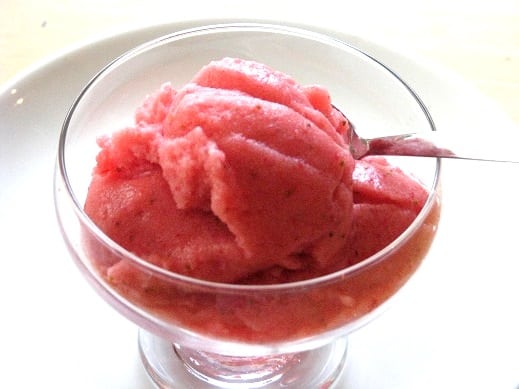 glass ice cream bowl with strawberry slush and spoon