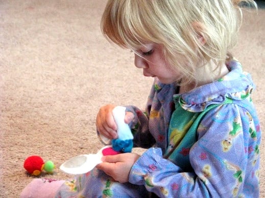 little girl playing with felt make up