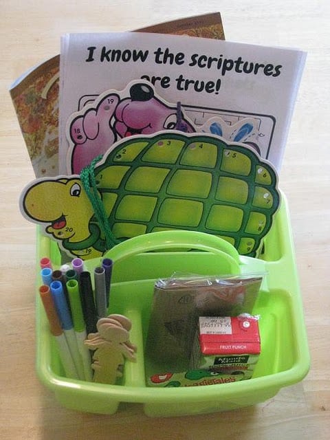 green tote with markers and activities and a juice box