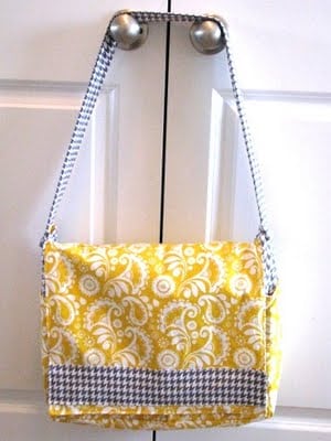 yellow messenger bag hanging on door knob