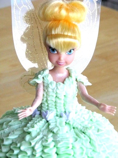 tinkerbell toy covered in frosting for tinkerbell cake