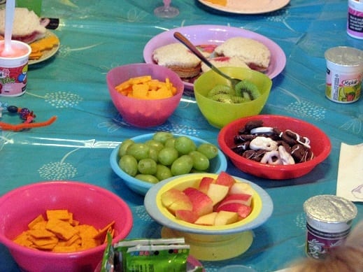 fruit and crackers and snacks in small bowls