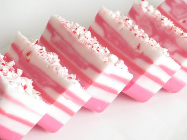 6 candy cane soaps arranged on white surface