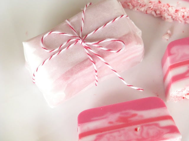 candy cane soap wrapped in parchment paper and tied with string