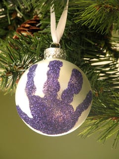 glass ornament with purple handprint