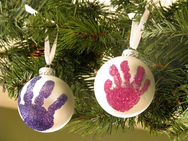 two handprint ornaments on christmas tree