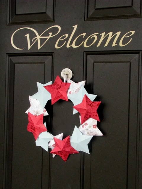 winter themed paper wreath on black door