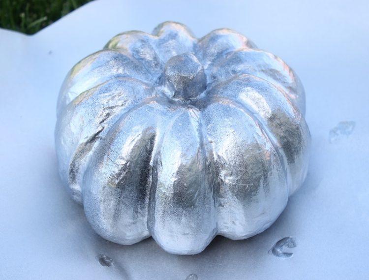 pumpkin painted with second coat of silver paint