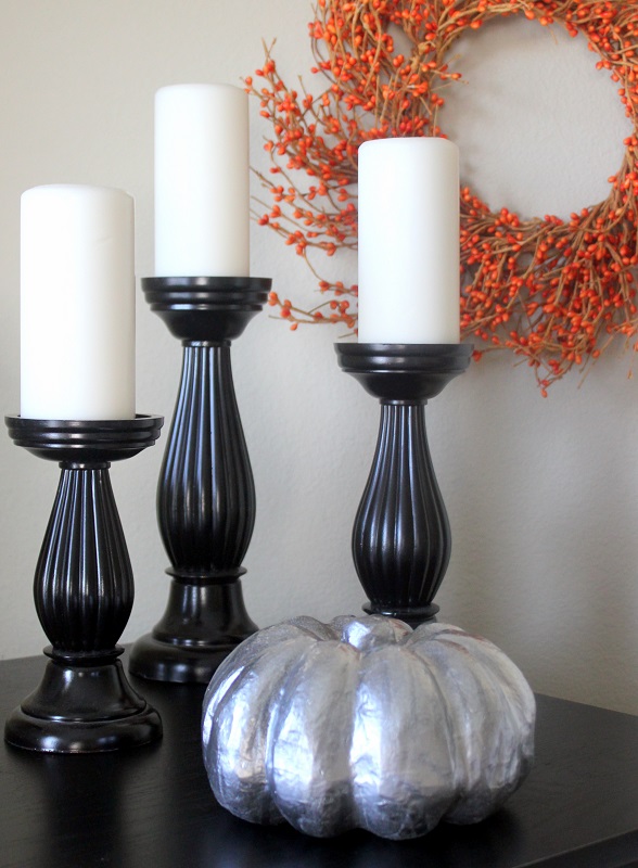 black candlesticks and silver pumpkin