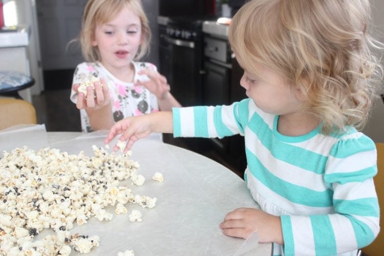 little girls eating popcorn