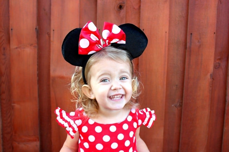 little girl wearing Minnie Mouse headband ears