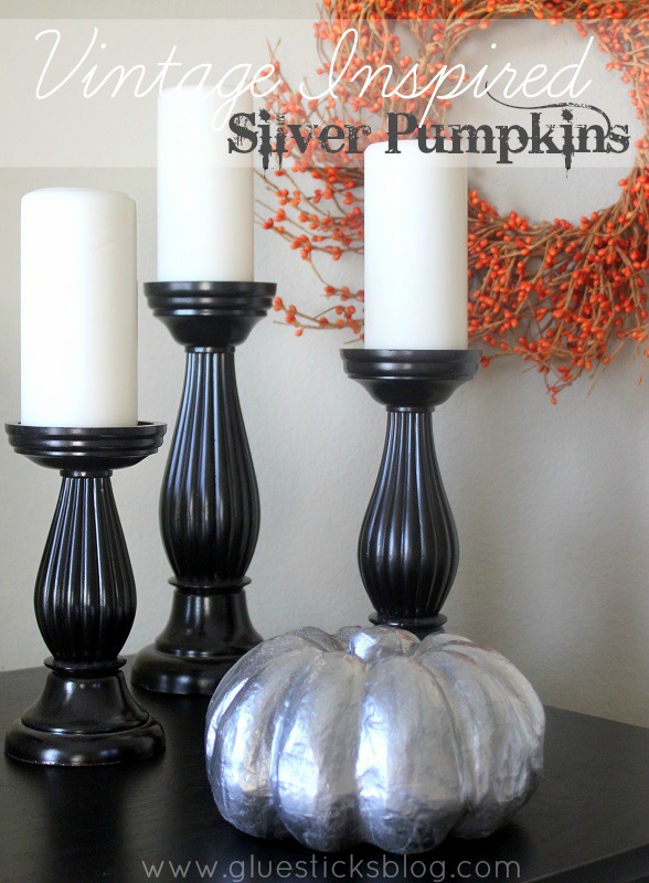 black candlesticks and silver pumpkin
