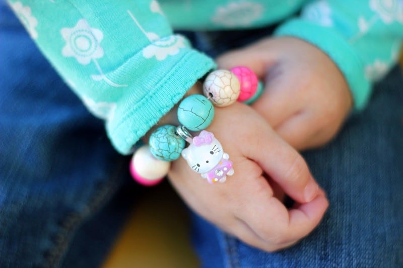 little girl wearing charm bracelet
