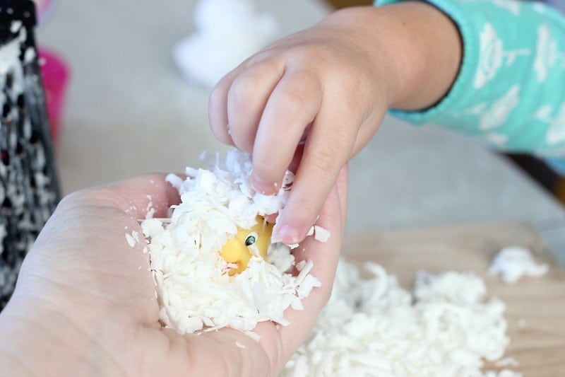 packing soap shavings around small fish toy