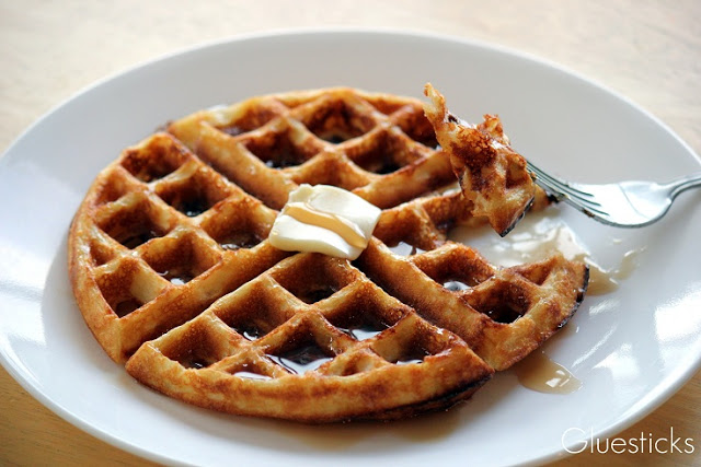 waffle on plate with fork cutting out a piece