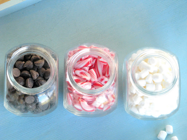 candy jars filled with chocolate chips and marshmallows and peppermint candy