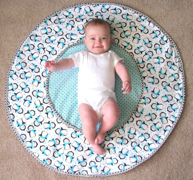 baby laying on play mat
