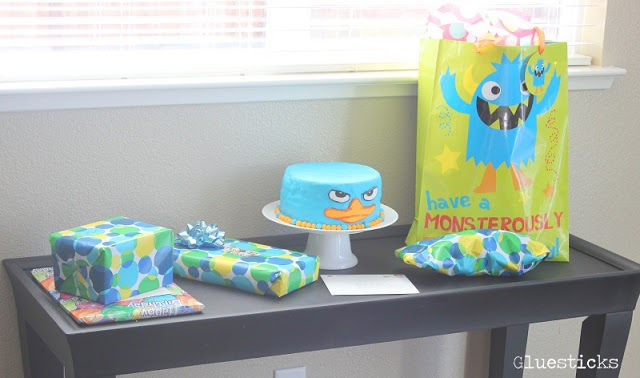 Perry the platypus cake on table with presents