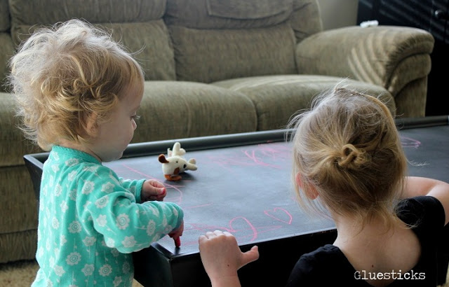 children drawing on chalkboard table