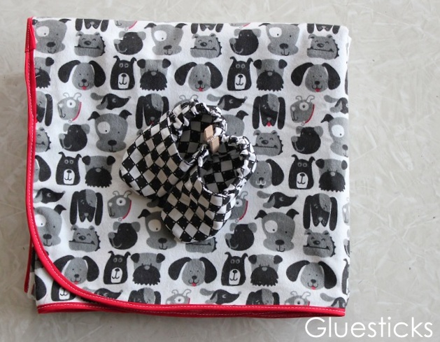 folded blanket with baby shoes