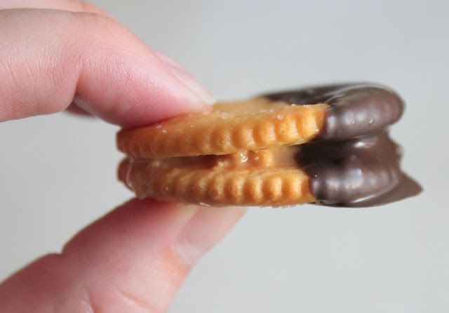 two ritz crackers with peanut butter and dipped in chocolate