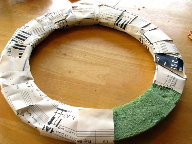 frame base wrapped in sheet music strips