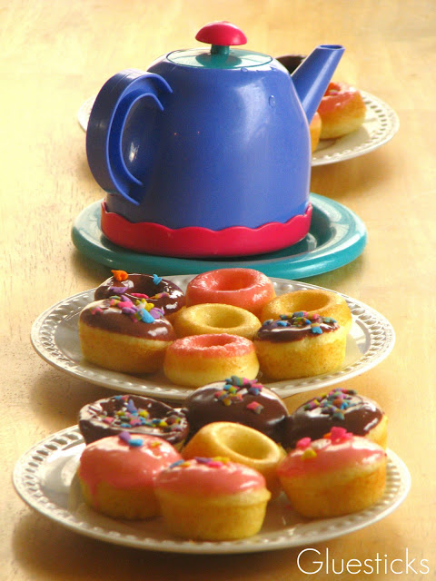 plates of mini donuts and plastic tea pot