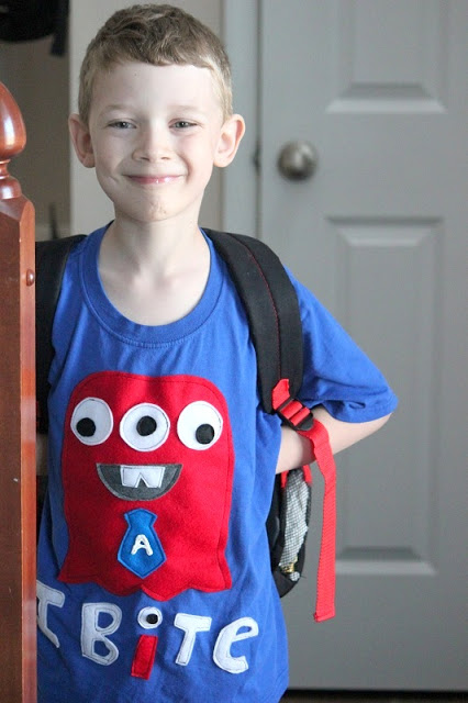 boy wearing blue monster shirt