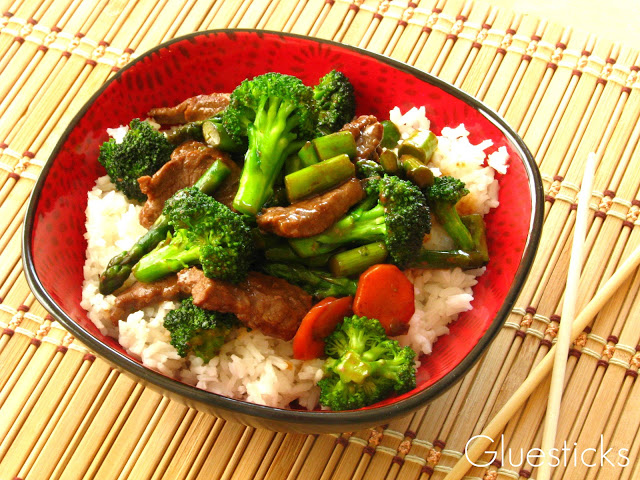 steak stir fry in red bowl with chop sticks