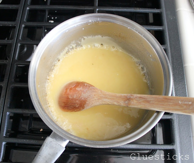 sauce pan with melted butter, sugar, and vanilla and wooden spoon