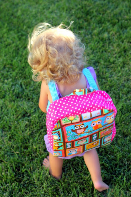 toddler wearing homemade backpack
