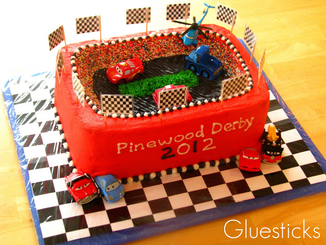 race track themed cake on cake board