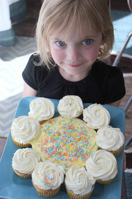 little girl with flower cupcake cake
