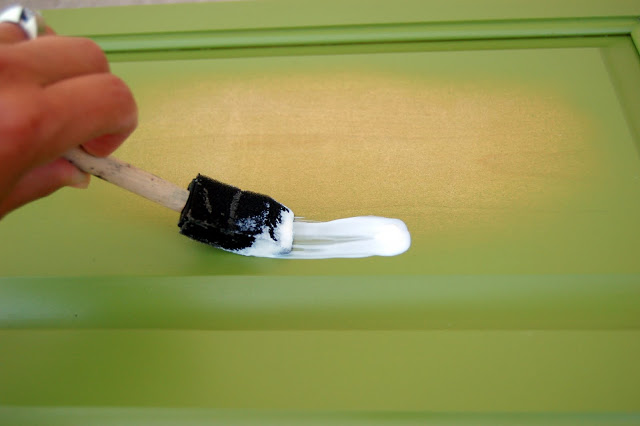 sponge brush painting mod podge onto desk front