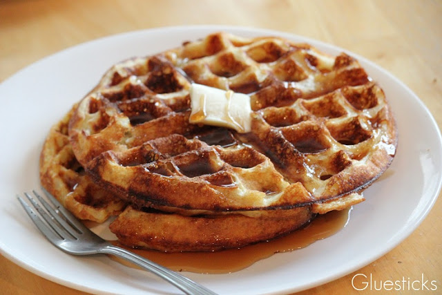 crispy waffles with syrup and butter on plate