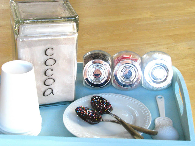 blue wooden tray with cocoa mix and chocolate spoons